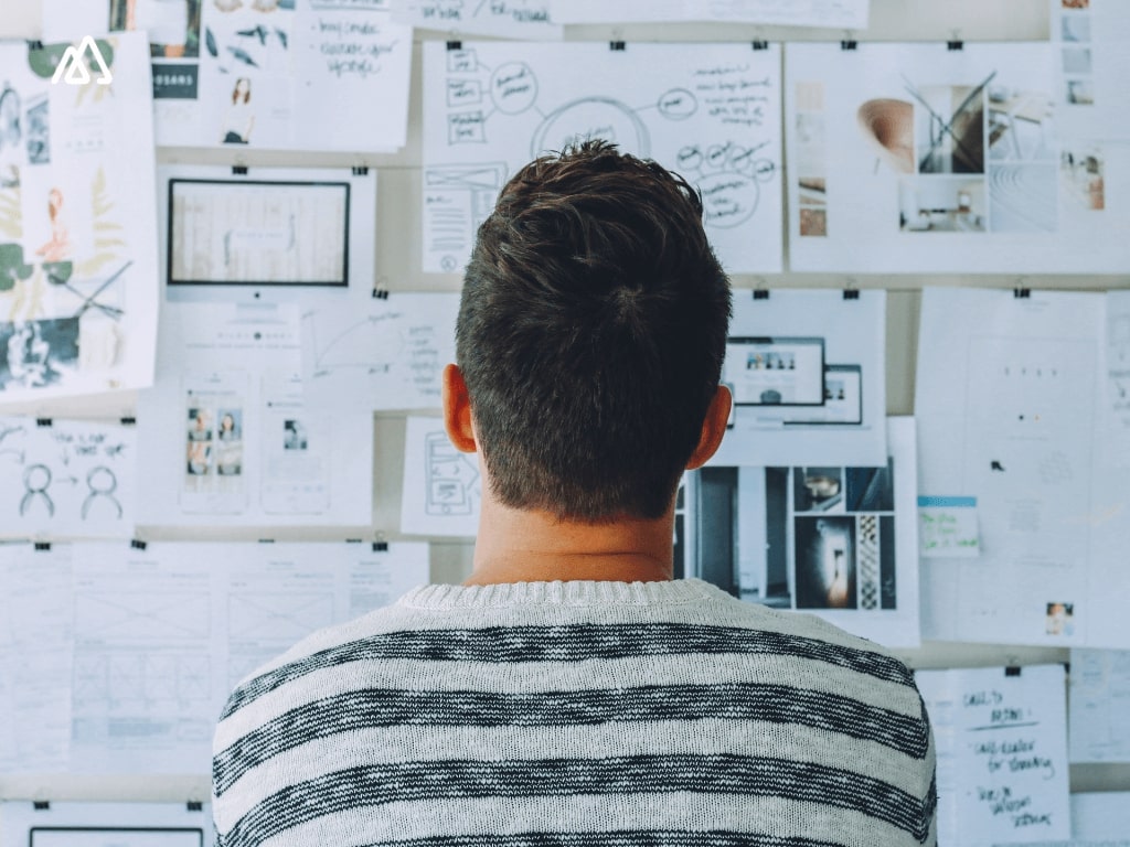 Man Looking a t a vision board Crm for startups